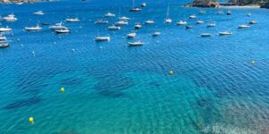 Costa Brava boats anchored at transparent waters Cadaqués bay